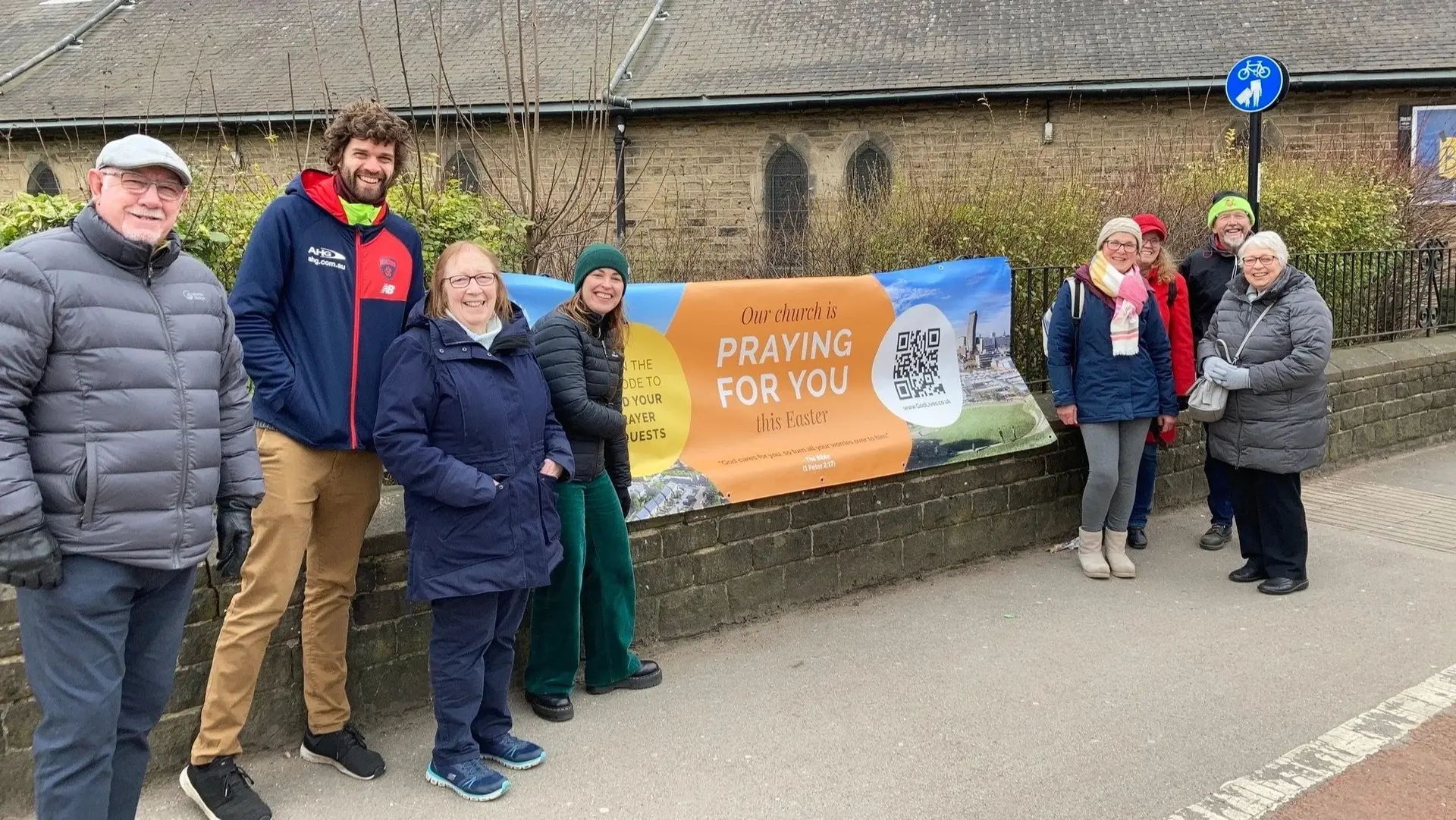 A group of church volunteers praying for their city on a Sheffield street